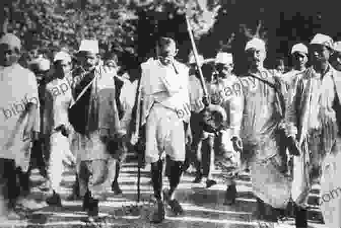 A Black And White Photo Of Mahatma Gandhi Leading A Large Group Of People On A March To The Sea, Holding Up A Walking Stick And Surrounded By Supporters. Gandhi S Passion: The Life And Legacy Of Mahatma Gandhi